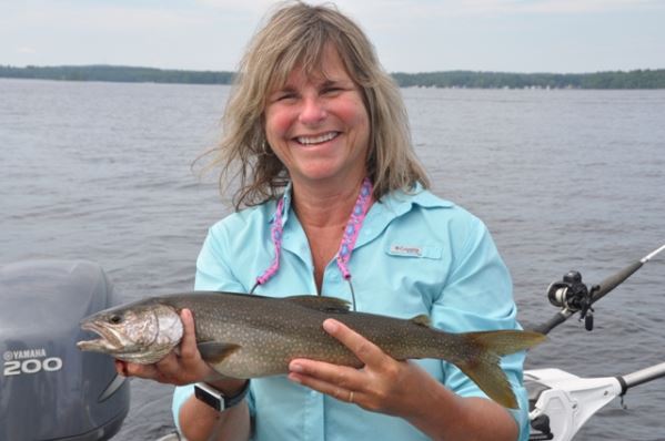 The author’s wife Maria with a lake trout, along with landlocked salmon and smallmouth bass, one of the more popular gamefish among Sebago Lake anglers.